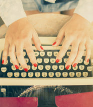 Woman Typing On A Typewriter